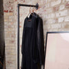 Wall mounted clothes rail with support to the floor made from dark iron pipes